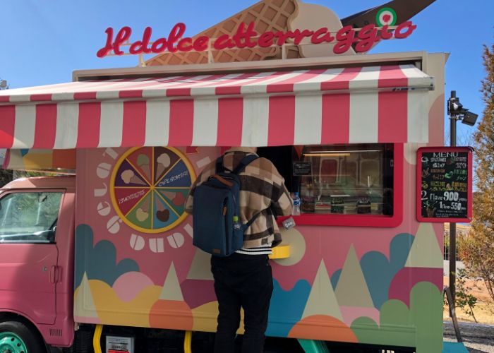 The gelato van at Ghibli Park. A man is ordering.